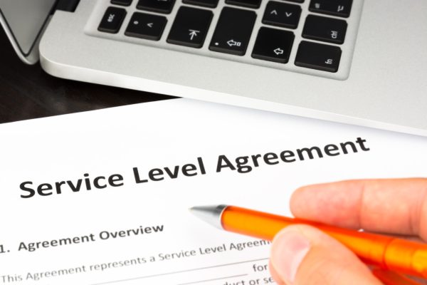 Service,Level,Agreement,Contract,Form,With,Hand,And,Pen